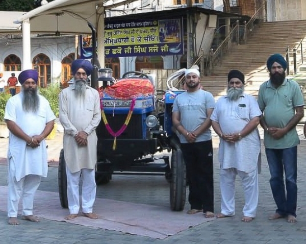 ਭੇਂਟ ਕੀਤੇ ਟਰੈਕਟਰ ਨਾਲ ਕਮੇਟੀ ਮੈਂਬਰ।